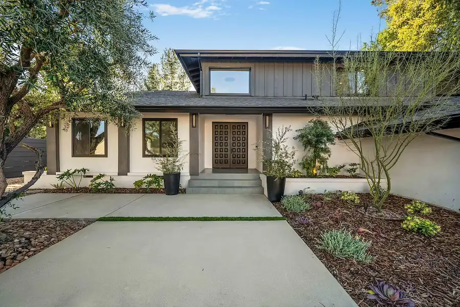 Modern exterior of a home with landscaped front yard and stylish entryway.