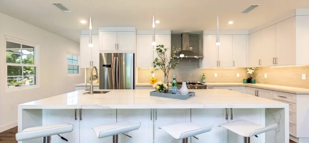 Bright kitchen with white cabinetry and quartz countertops