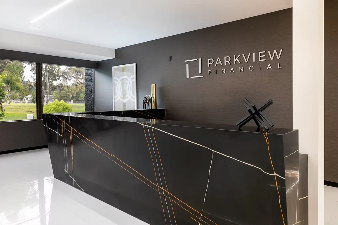 Commercial office reception desk with black marble design for Parkview Financial.