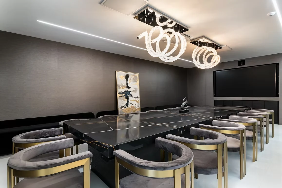 Modern conference room with black marble table and luxurious crystal chandeliers.