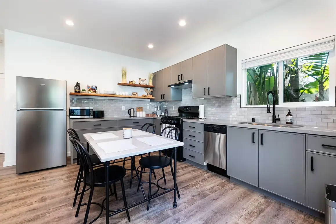 Contemporary kitchen with gray cabinets and sleek appliances.
