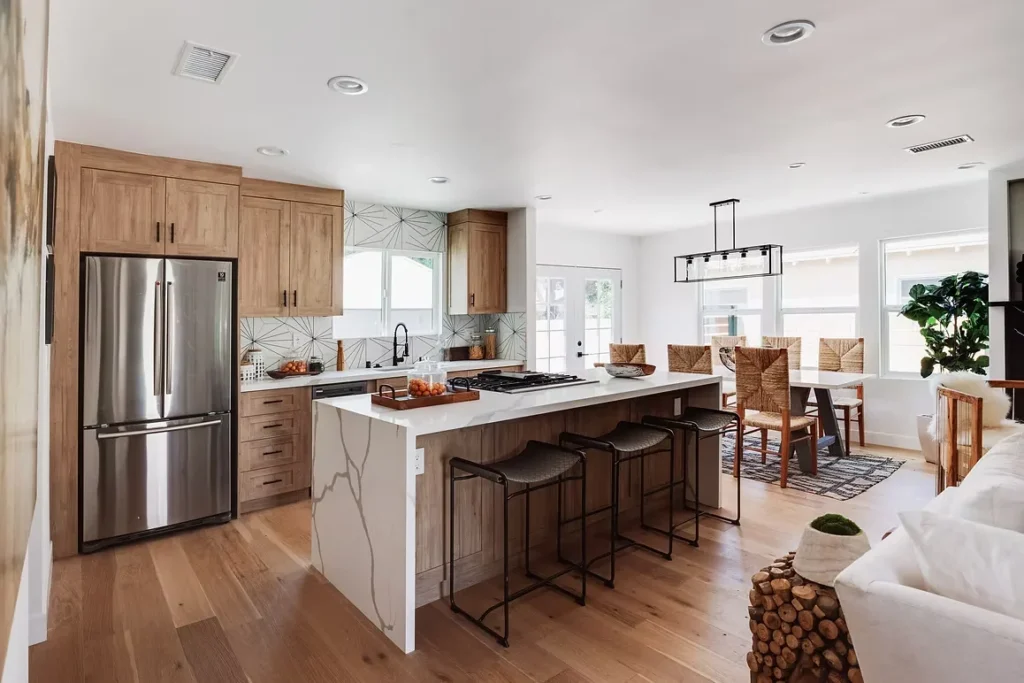 Modern kitchen remodel with wood cabinets, stainless steel appliances, and a stylish open layout.