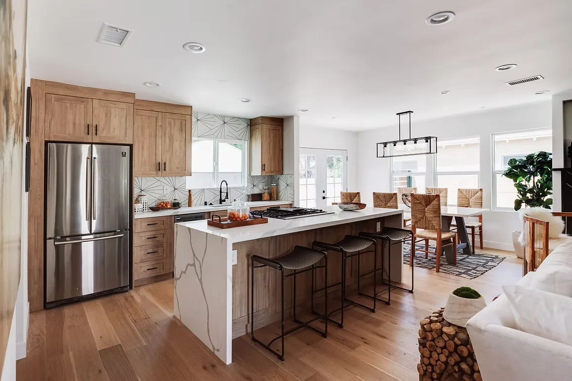 Modern kitchen remodel with wood cabinets, stainless steel appliances, and a stylish open layout.