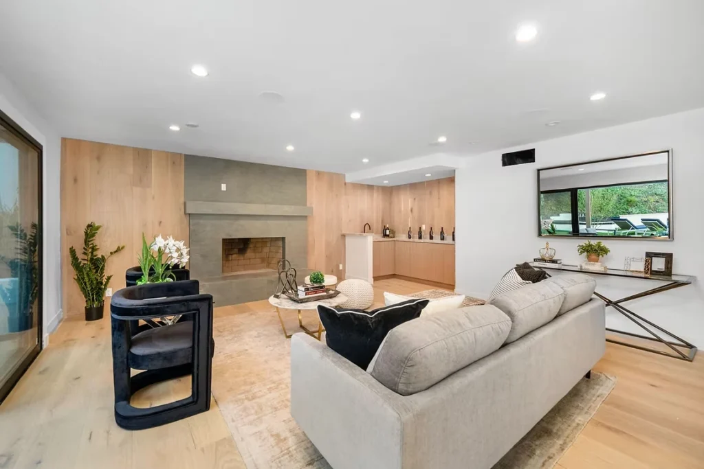 Modern living room with neutral tones, cozy seating area, and contemporary fireplace