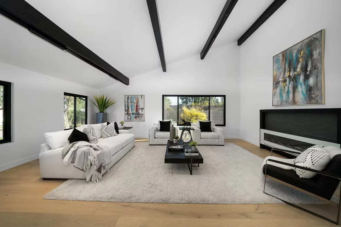 Spacious living room with vaulted ceilings, stylish furniture, and modern design.