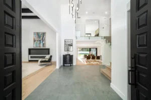 Elegant open concept living area with modern decor, high ceilings, and contemporary lighting.