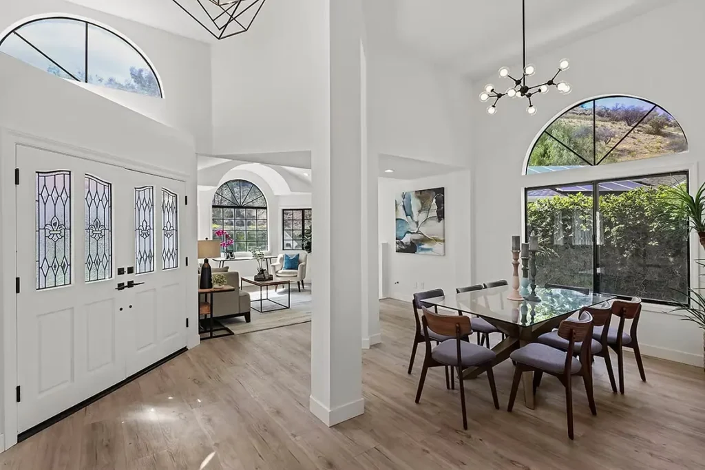 Spacious living room with modern furniture and lighting.